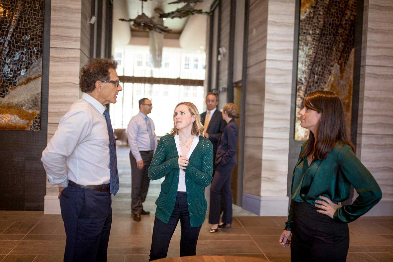 Attorneys chatting in naturally lit lobby